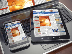 tablet and laptop with news